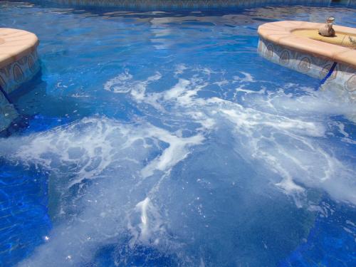 a swimming pool with blue water in it at Dar Aladin in Arkou