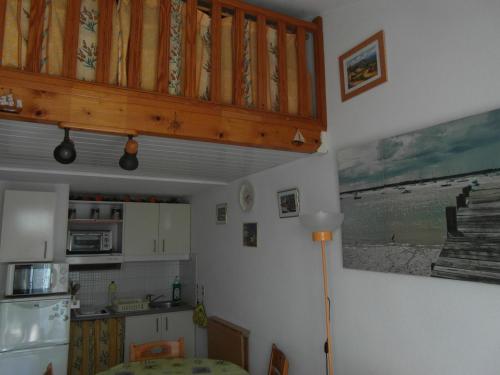 Il comprend une cuisine équipée d'un réfrigérateur et d'une table. dans l'établissement Résidence Hameau du Soleil à 250 m de la plage, à Valras-Plage