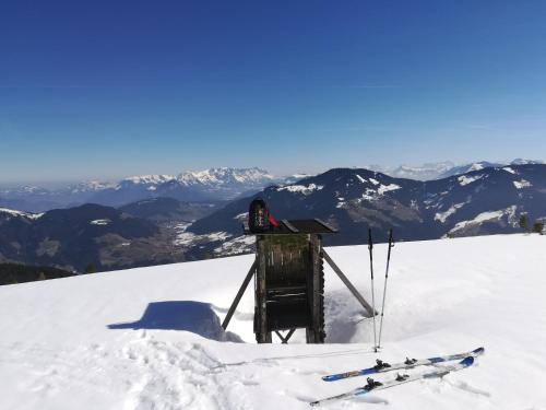 a small shack on top of a snow covered mountain at Holzfällerhaus Melkstatt in Auffach