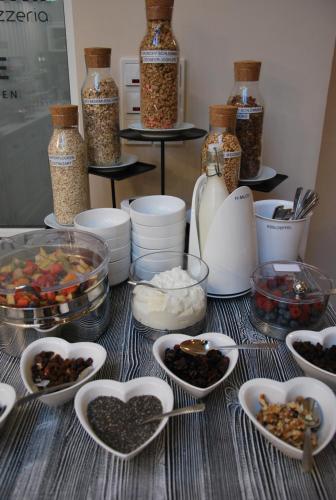 a table topped with bowls of food and other ingredients at Hotel Colosseum in Rheinböllen