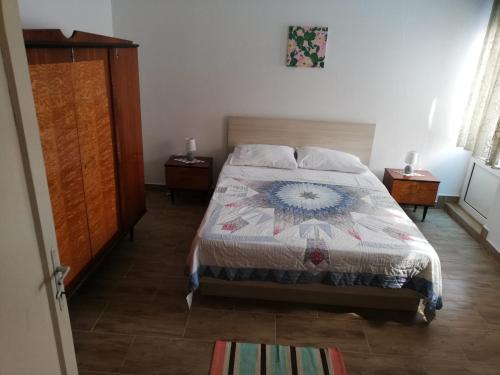 a bedroom with a bed with a quilt on it at Ani in Povljana