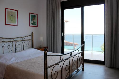 a bedroom with a bed and a view of the ocean at panorama studios in Afitos
