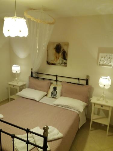 a bedroom with two beds and two lamps at Themis Apartments in Sami