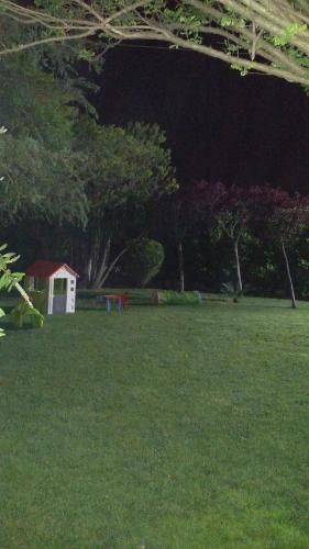 a field of grass with a white shed in the background at B&B Villa dei Sogni in Eboli