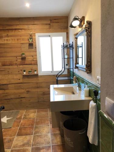 a bathroom with a sink and a mirror at El Cortijillo in Alfaíz