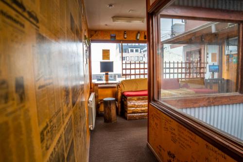 a small room with a bed and a window at Hostel Cruz del Sur in Ushuaia