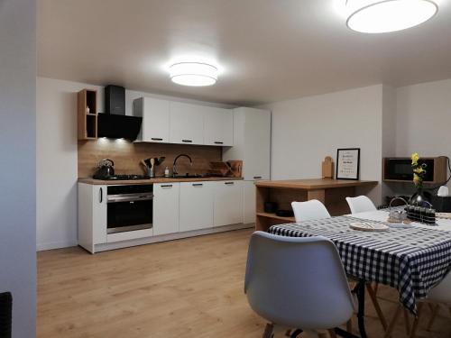 a kitchen and dining room with a table and chairs at Pokoje Na Szlaku in Lądek-Zdrój