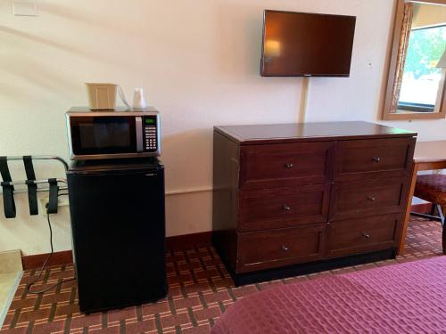 a microwave on top of a dresser in a room at Royal Regency Inn in Rock Hill