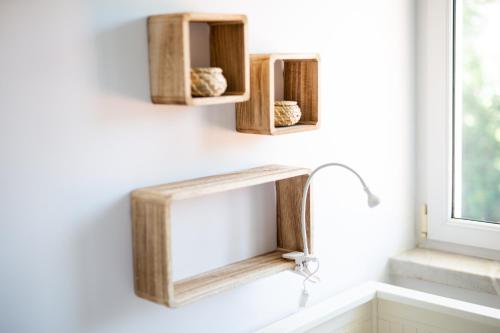 a bathroom sink with a wooden mirror and a window at Sunny Soul in Malveira da Serra