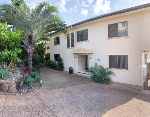 a large white house with a large window at Island Views in Airlie Beach
