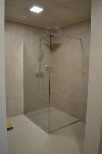 a shower with a glass door in a bathroom at B&B Allegambe's Goed in Zedelgem