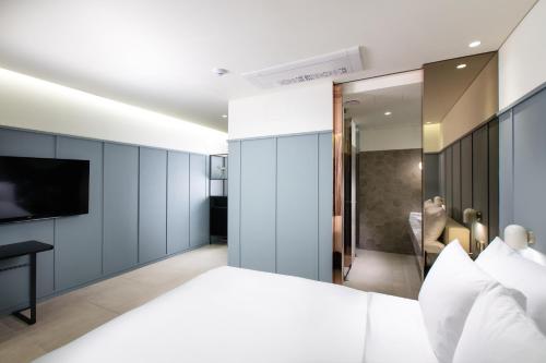a bedroom with a large bed and a television at Park Marine Hotel in Incheon