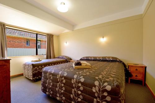 Postel nebo postele na pokoji v ubytování Mosgiel Regency Motel