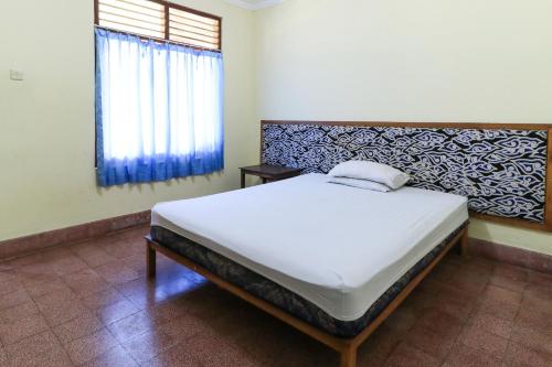 Postel nebo postele na pokoji v ubytování Mertha Jati Hotel