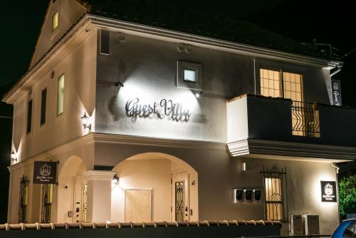 a building with a sign on the side of it at Guest Villa Hakone Yumoto RiverSide in Hakone