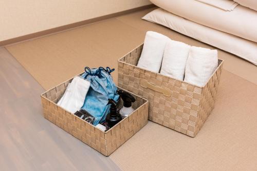 two boxes of towels and towels on the floor at Guest Villa Hakone Yumoto RiverSide in Hakone