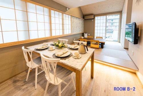 a dining room with a table and chairs at Guest Villa Hakone Yumoto RiverSide in Hakone