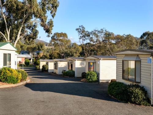a row of white homes in a row at Discovery Parks - Hobart in Hobart