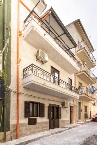 an apartment building with balconies and a balcony at IN CENTRO ROOMS Vicino Cefalù SELF-CHEK-IN in Campofelice di Roccella