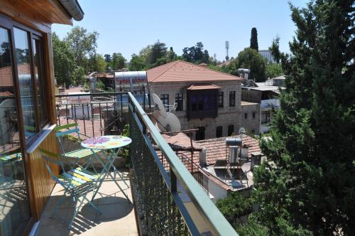 a balcony with a table and chairs on a building at Sibel Hotel in Antalya