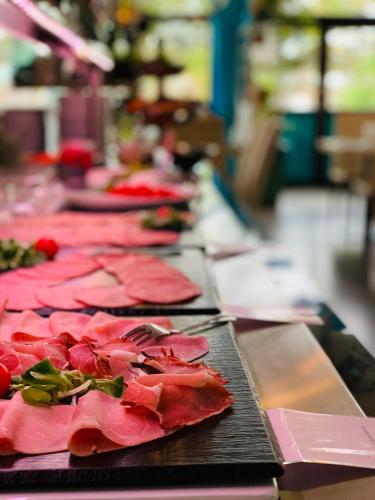a row of plates of food on a table at Aqua Hotel in Konstanz