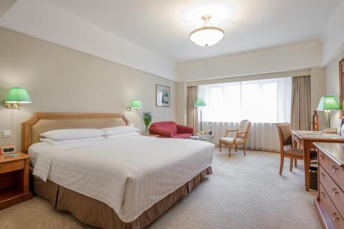 a hotel room with a bed and a desk at JEN Shenyang by Shangri-La in Shenyang