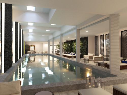 a large swimming pool in a hotel lobby at Le Centell Hotel & Spa in Antananarivo