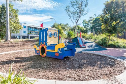 a playground with a toy train in a park at The Brighton Apartments in Toronto