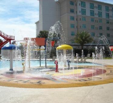 a water fountain with a fire hydrant in front of a building at Seven Clans Hotel at Coushatta in Kinder