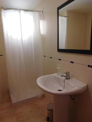 a bathroom with a sink and a mirror at El apartamento de Marina en Chilches playa in Xilxes