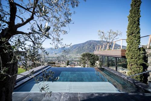 a swimming pool in the middle of a house at SPA & Relax Hotel Erika in Tirolo
