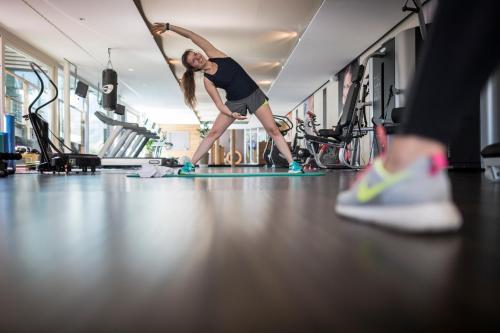 a woman doing a push up in a gym at SPA & Relax Hotel Erika in Tirolo