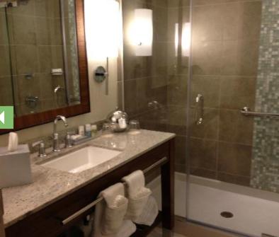 a bathroom with a sink and a shower at Seven Clans Hotel at Coushatta in Kinder
