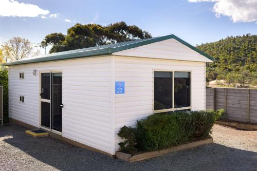 
a white and blue building with a blue roof at Discovery Parks - Mornington Hobart in Warrane
