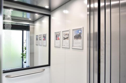 a room with a window and pictures on the wall at Hotel Perla in Herceg-Novi