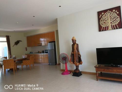 a living room with a statue of a woman with a fan at Hua Hin Blue Lagoon in Cha Am