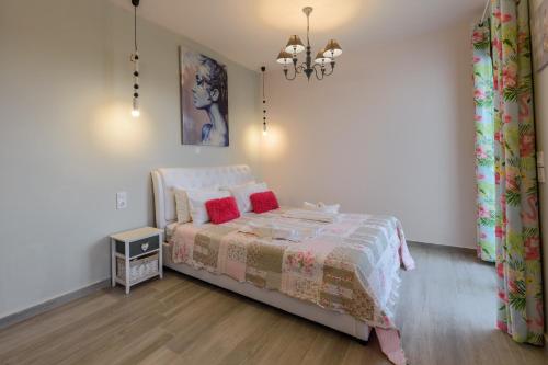a bedroom with a bed with red pillows at Olympus Studios in Malia