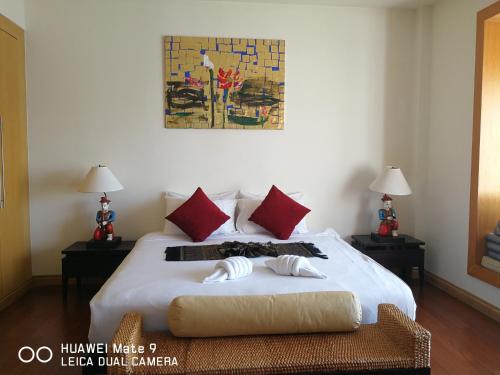 a bedroom with a bed with two towels on it at Hua Hin Blue Lagoon in Cha Am