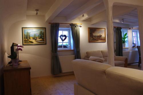 a living room with a couch and two windows at Alte Bäckerei in Monschau