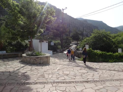 a group of people walking down a stone sidewalk at Villa Kalliopi ΙnCreteble Cretan Resindences Collection in Xerokampos