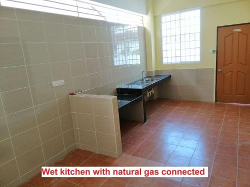 a bathroom with a sink and a toilet in a room at HomezStay Airport Miri in Miri