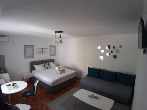 a living room with a bed and a couch at Brana Gorica Apartments in Trebinje