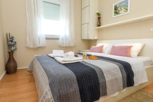 a bedroom with a large bed with towels on it at Adriana's Dream View 2 bedrooms apartment in Zadar