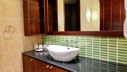 a bathroom with a sink and a mirror at Hua Hin Blue Lagoon in Cha Am