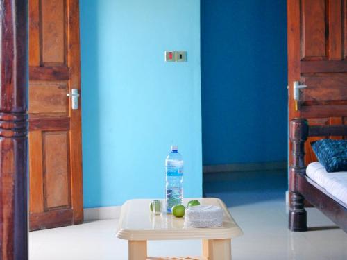 a bottle of water sitting on a table next to a door at Young Safari Hotel in Malindi