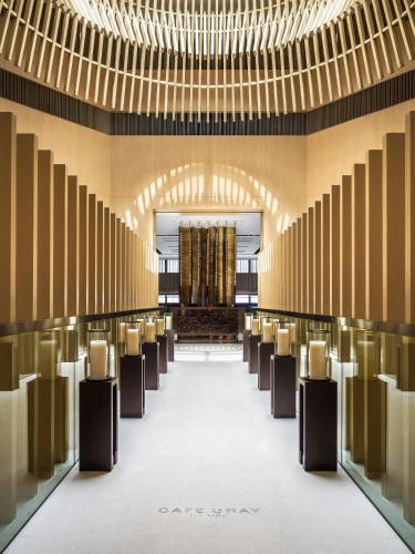 a row of chairs in a large room with chandeliers at The Upper House in Hong Kong