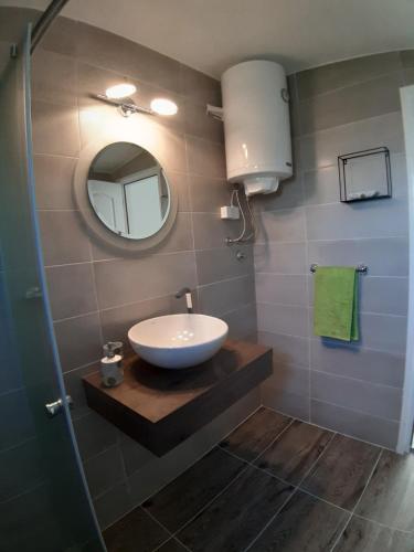 a bathroom with a sink and a mirror at Brana Gorica Apartments in Trebinje