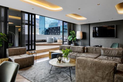 a living room filled with furniture and a large window at The Onyx Apartment Hotel in Cape Town