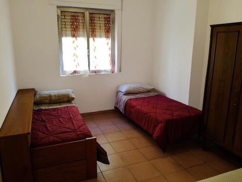 En eller flere senge i et værelse på Appartamento a Villapiana Lido