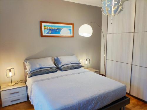 a bedroom with a large bed with blue pillows at Bed & Smile in Valeggio sul Mincio